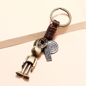 Vintage handmade leather robot rabbit keychain with brass metal accents and engraved charm