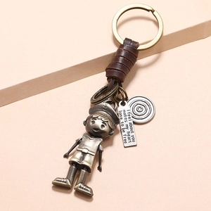 Vintage braided leather keychain featuring a bronze robot boy and engraved metal charm