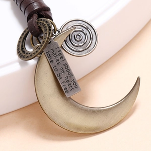 Handmade leather keychain with bronze crescent moon pendant and engraved quote tag