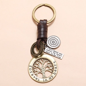 Handcrafted leather keychain with a bronze tree of life charm and heart engraving