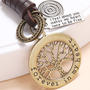 Handmade leather keychain featuring bronze Tree of Life and engraved silver pendants