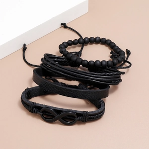 Detail of four-piece black multilayer braided leather bracelet with infinity symbol charm