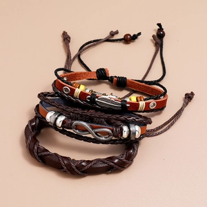 Detail of layered leather bracelets featuring infinity symbol and feather charms