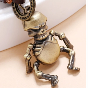 Vintage bronze skull keychain featuring intricate braided design and metallic details