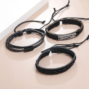 Détail du lot de trois bracelets en cuir noir tressé avec plaque métallique Love
