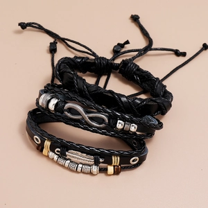 Close-up of woven leather bracelets with infinity symbol and feather charm detail