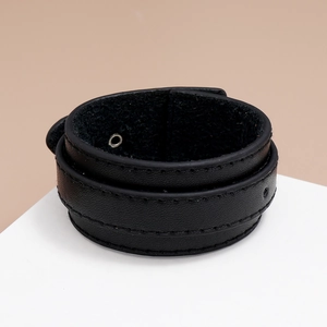 Detail of black multilayer PU leather bracelet with visible stitching and metal eyelets