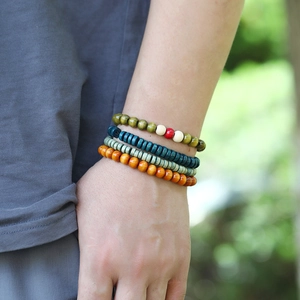 Detail of four-piece set handmade wooden bead bracelets with bohemian ethnic style