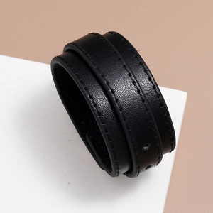 Detail of double-layer black PU leather bracelet with stitching and adjustable holes