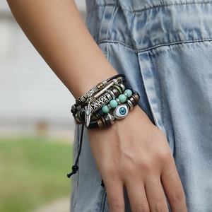 Bohemian multilayer leather bracelet with blue evil eye beads and feather charm pendant