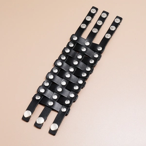 Detailed view of punk wide braided leather bracelet with silver studs and snap buttons