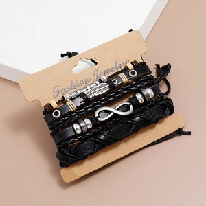 Close-up of multilayer leather bracelet set with feather and infinity metal charms