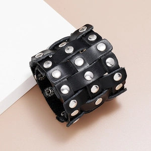 Detail of vintage punk wide leather bracelet with silver rivets and adjustable metal snaps