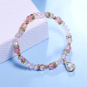 Detail of pink strawberry crystal bracelet with water drop pendant and gold beads
