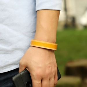 Vintage geel leren armband voor heren en dames om de pols gedragen in de buitenlucht