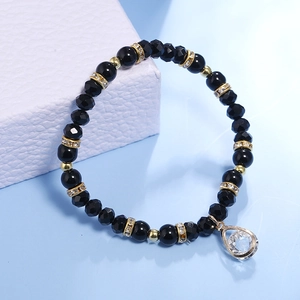 Elastic beaded bracelet with black polished beads and a sparkling water drop pendant