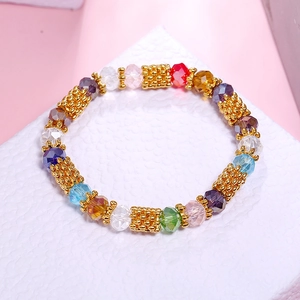 Detailed macro view of colorful faceted crystal beads and textured golden metal spacers