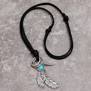 Ethnic silver feather pendant necklace with turquoise bead on black leather cord