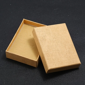 Beige linen texture jewelry gift box for earrings and necklaces on black background
