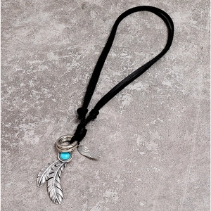 Ethnic style black leather cord necklace with silver feather pendant and blue turquoise stone