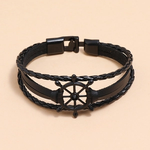 Detail showing multilayer black leather braid and nautical rudder anchor on men's bracelet