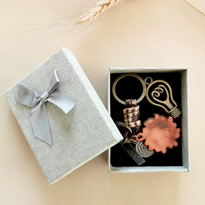 Retro braided leather keychain with engraved pendant in a grey gift box with a bow