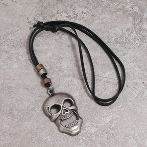 Punk style skull pendant on black leather cord with vintage metal beads for men