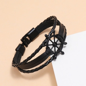 Men's black woven leather nautical bracelet featuring a metal rudder charm centerpiece