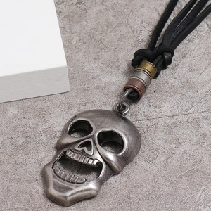 Vintage skull pendant on black leather cord with industrial rustic metal charms
