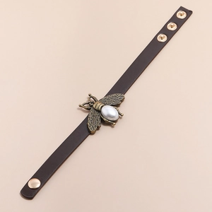 Retro wide dark brown leather bracelet featuring a gold bee and pearl accent with snap button