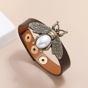 Vintage brown leather wide bracelet featuring a large bronze bee with a faux pearl inlay