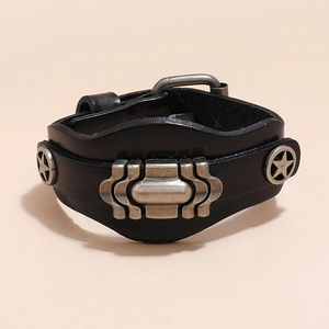 Detail of punk multi-layer black leather bracelet with vintage silver wave metal and star studs