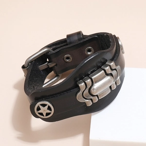 Detail of vintage multilayer leather bracelet with silver star rivets and metal wave plate