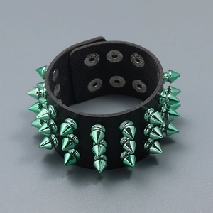 Detail of black punk leather bracelet with three rows of cyan metallic spikes and snap buttons