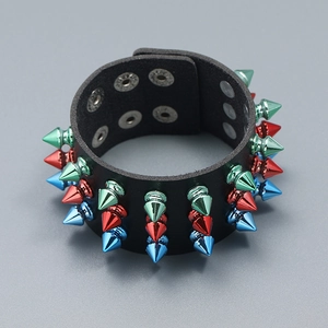 Detailed view of three-row colorful metallic spikes on a black punk leather bracelet