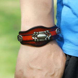 Retro multi-layer leather bracelet for men with metal stars and buckle on grassy background