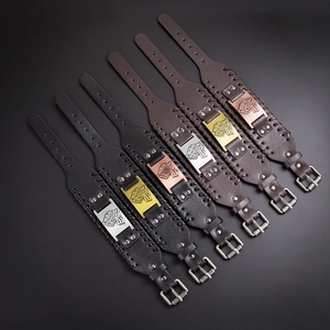 Detailed view of Nordic Viking wolf head bracelets with leather straps and metal buckles