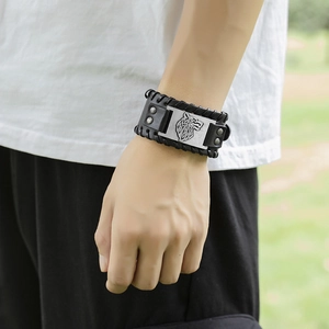 Detail of viking wolf head emblem on vintage braided leather bracelet for men