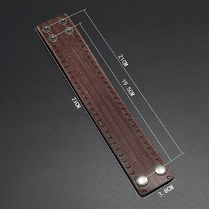 Detailed view of retro brown leather wide wristband with black conical rivets and dimensions