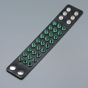 Punk black leather wristband with three rows of green spiked studs and silver snap buttons