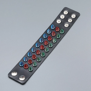 Punk leather bracelet with three rows of colorful spikes and adjustable silver snaps