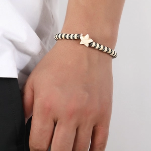Men's vintage beaded bracelet with neutral coconut shell discs and a white star charm
