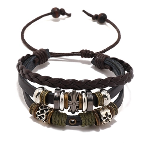 Multilayer beaded leather bracelet with cross charm and star details on white background