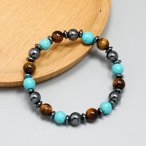 Bohemian beaded bracelet featuring turquoise and tiger eye stones on a wooden tray