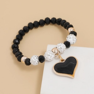 Detail of beaded bracelet with black crystals, rhinestone spheres and a black heart charm