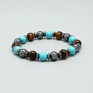 Bohemian beaded bracelet featuring turquoise and tiger eye stones on grey background