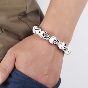 Minimalist white resin skull bead bracelet for men featuring detailed black carved accents