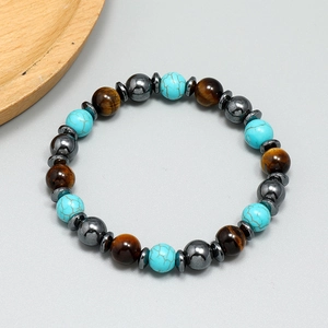 Bohemian beaded bracelet with turquoise, tiger eye stones and hematite on grey background