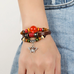 Multi-layer leather bracelet with beaded accents and a hollow silver butterfly pendant