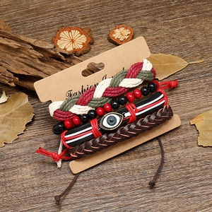 Bohemian multilayer braided leather bracelets set with evil eye charm on rustic wood